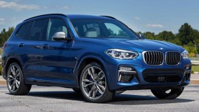 A blue 2018 BMW X3 small luxury SUV is parked.