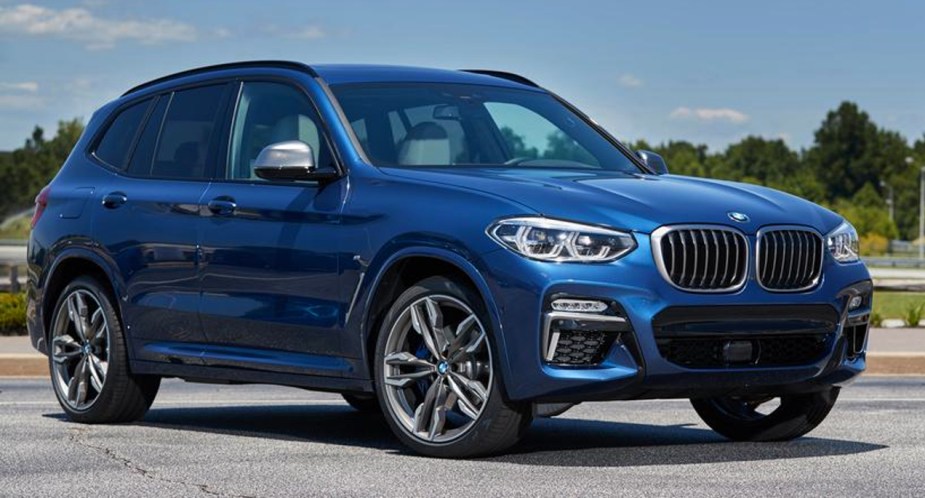 A blue 2018 BMW X3 small luxury SUV is parked. 