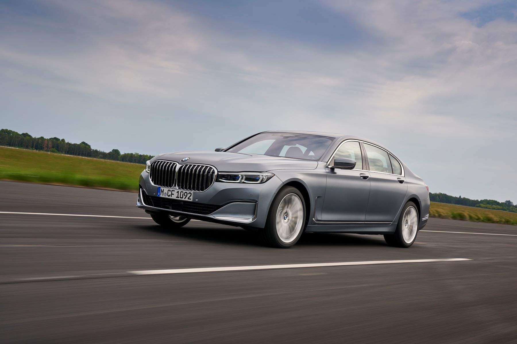 A silver-gray 2020 BMW 7 Series full-size luxury sedan model driving down a highway