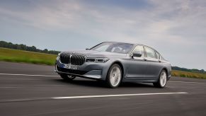 A silver-gray 2020 BMW 7 Series full-size luxury sedan model driving down a highway