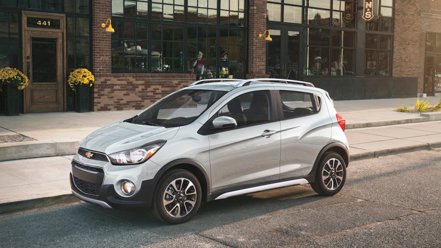 A silver Chevrolet Spark, which is the Chevrolet with the lowest insurance cost.
