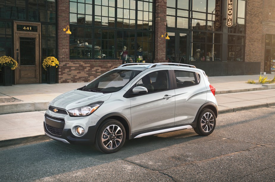 A silver Chevrolet Spark, which is the Chevrolet with the lowest insurance cost. 
