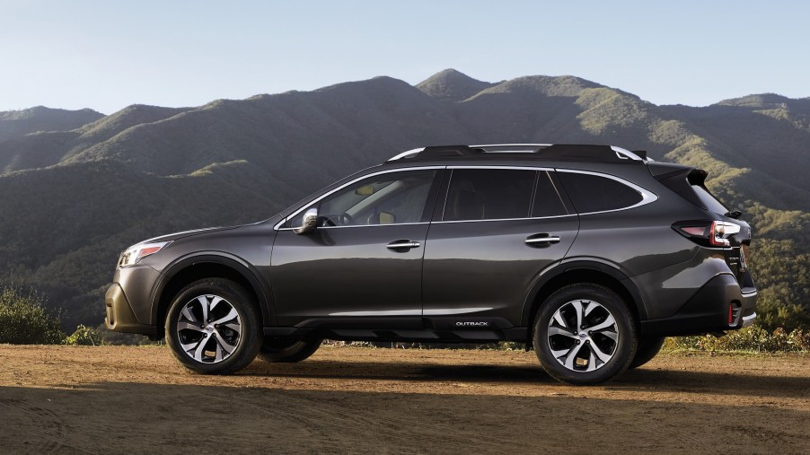 The 2022 Subaru Outback in black on a desert road. The Outback vs. Forester debate is a big one.