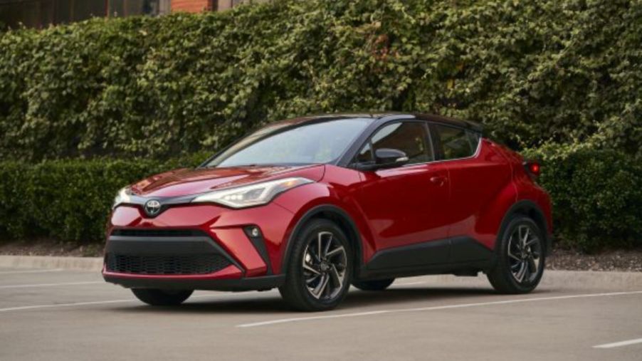A red Toyota C-HR in a parking lot.