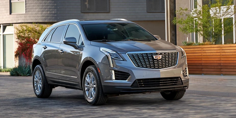 Gray 2023 Cadillac XT5 luxury SUV parked outside, price, features and other modifications.