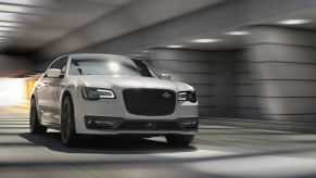 A white 2023 Chrysler 300C full-size executive car/luxury sedan model driving through a tunnel