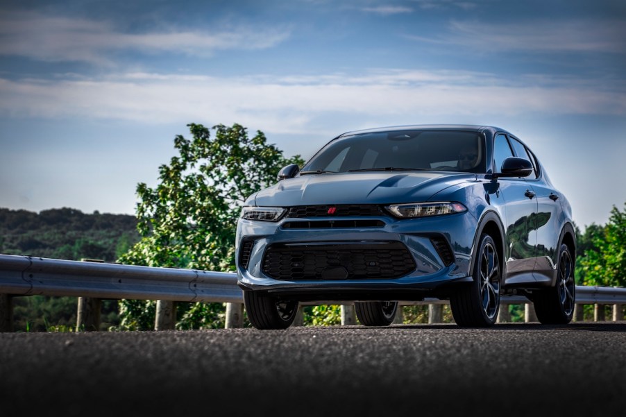 A blue 2023 Dodge Hornet parked on a roadway.