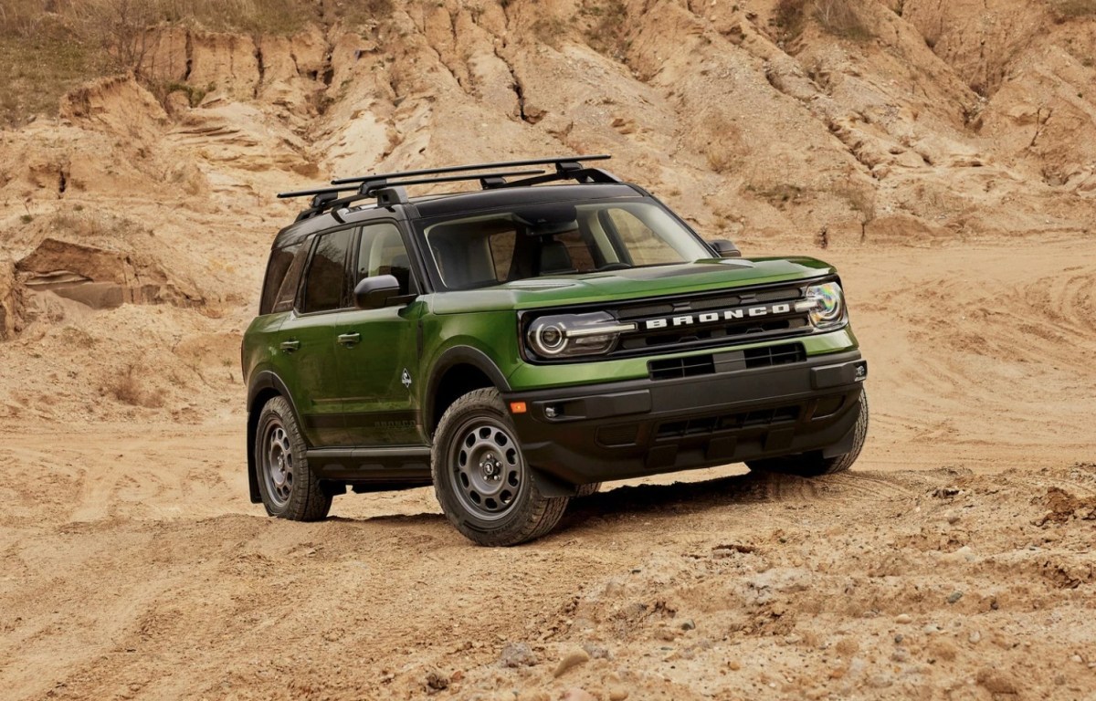 A green Ford Bronco Sport driving off-road.