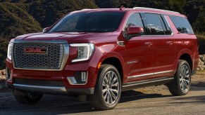 A red 2023 GMC Yukon XL full-size SUV is parked | General Motors