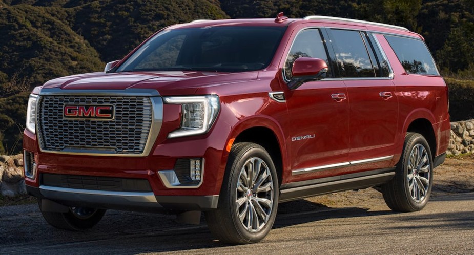 A red 2023 GMC Yukon XL full-size SUV is parked. 