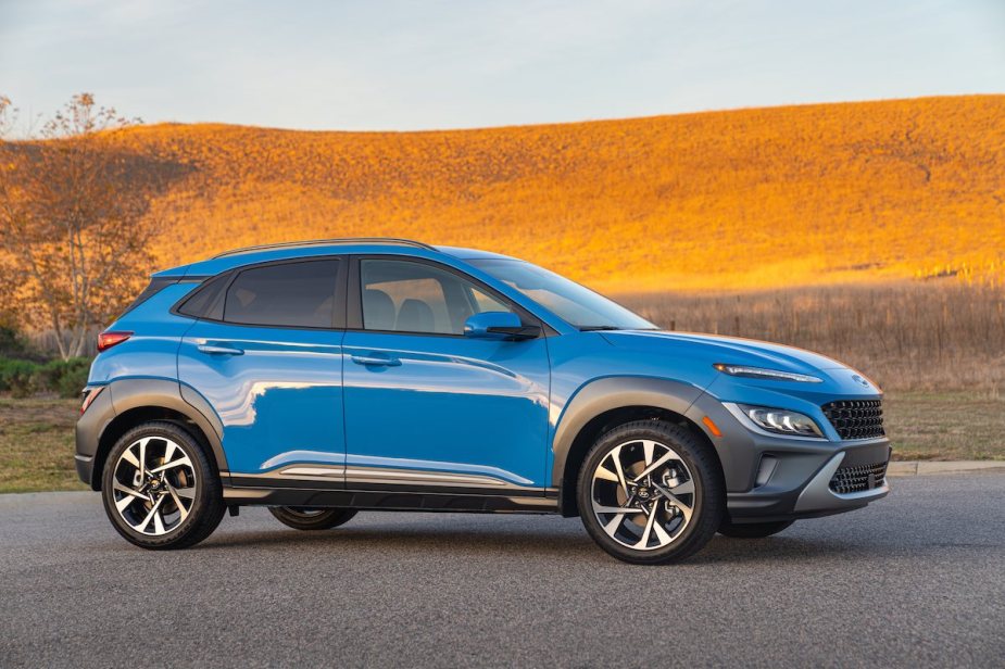 A light blue 2023 Hyundai Kona on a highway, which is a great SUV to buy.