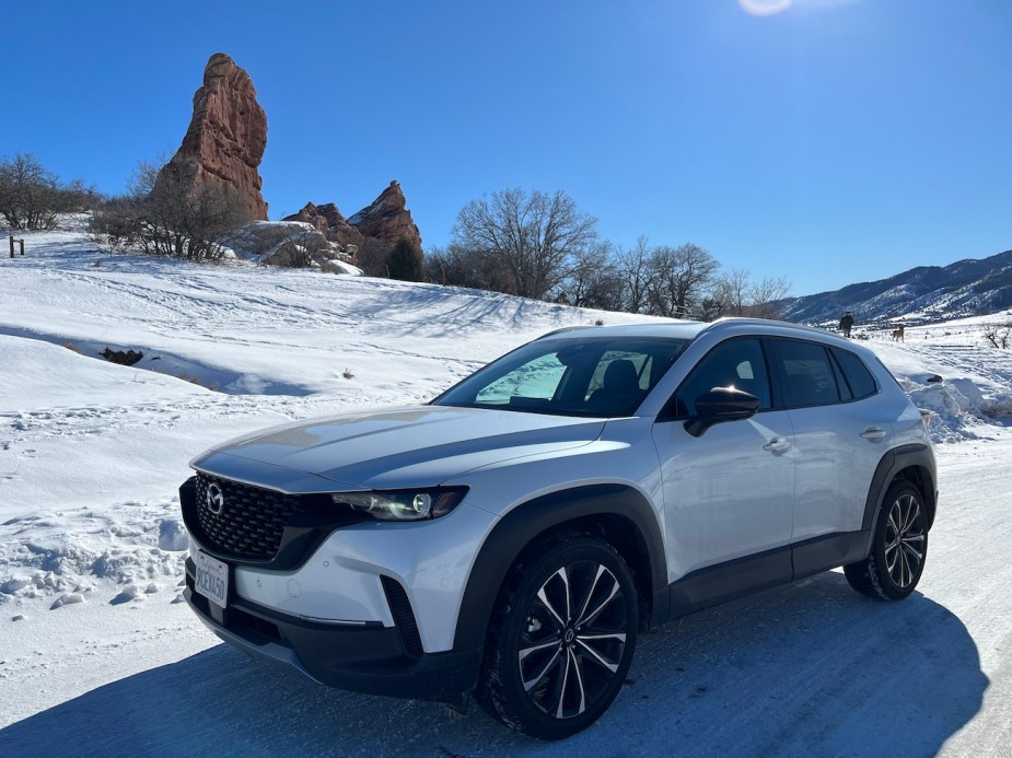 A white 2023 Mazda CX-50 front exterior view in the snow. 
