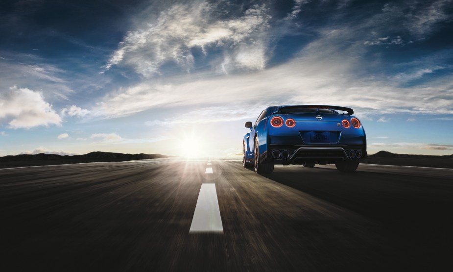 The Nissan GT-R blasts down a straight track, showing off its rear end style.