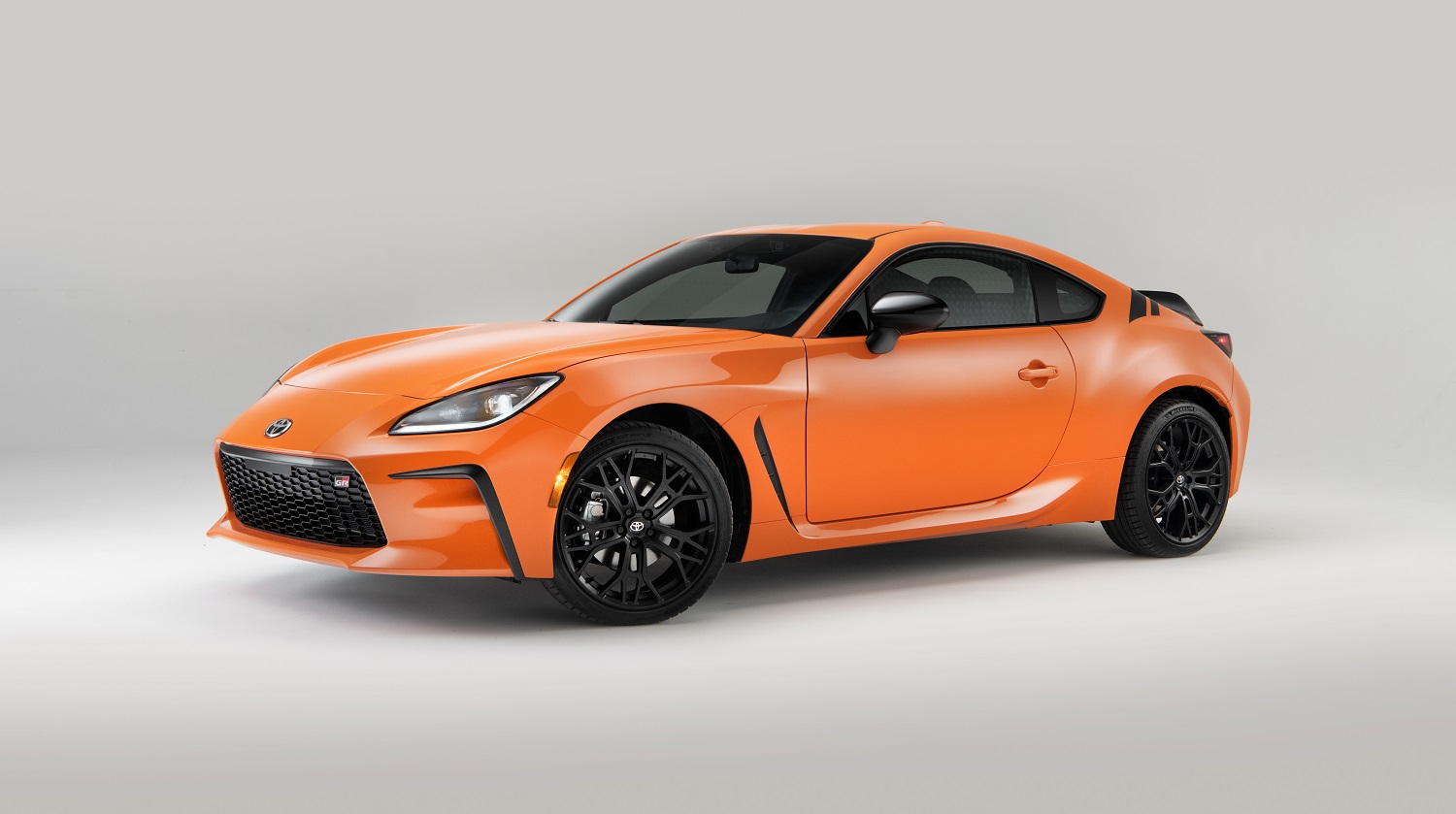 An orange Toyota GR86 on display.
