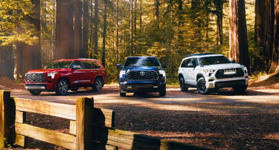 Three 2023 Toyota Sequoia full-size SUVs are parked outside. 