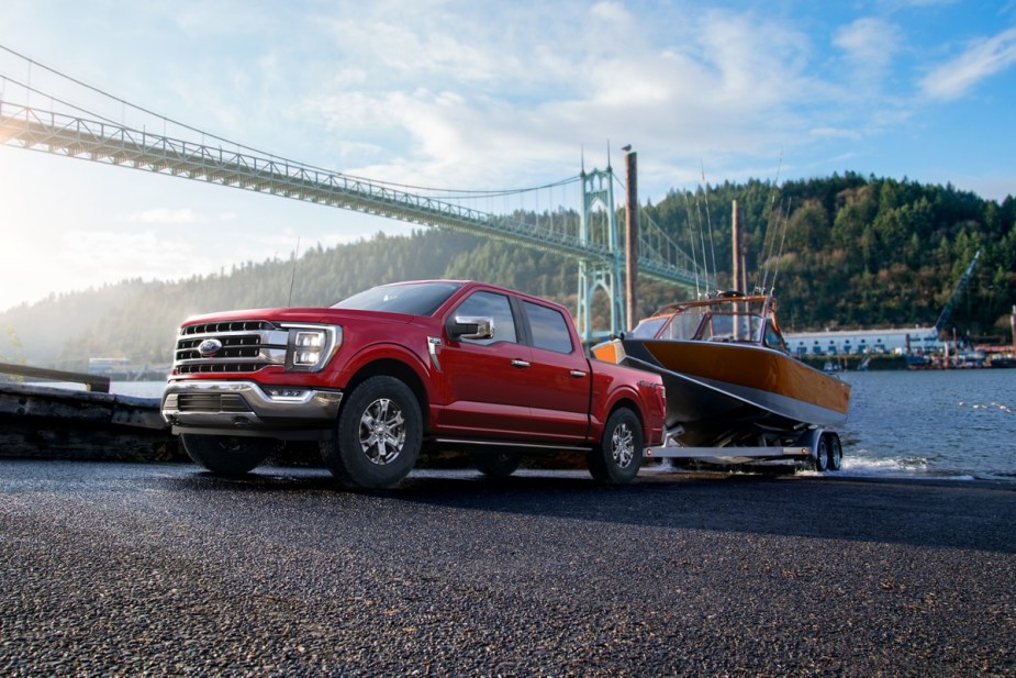 A red 2023 Ford F-150 tows a trailer as Edmunds Top Rated Truck