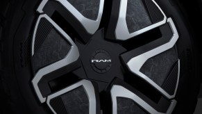 Detail shot of the Ram lettering on the Revolution electric pickup truck's rim.