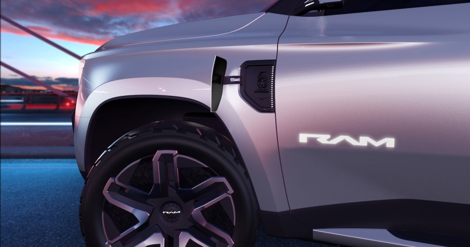 Closeup of the Ram Revolution's door badge and front tire, a sunset visible in the background.