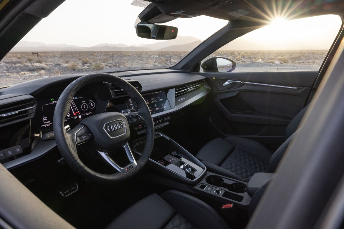 The interior of the 2023 Audi RS 3 on a desert background.