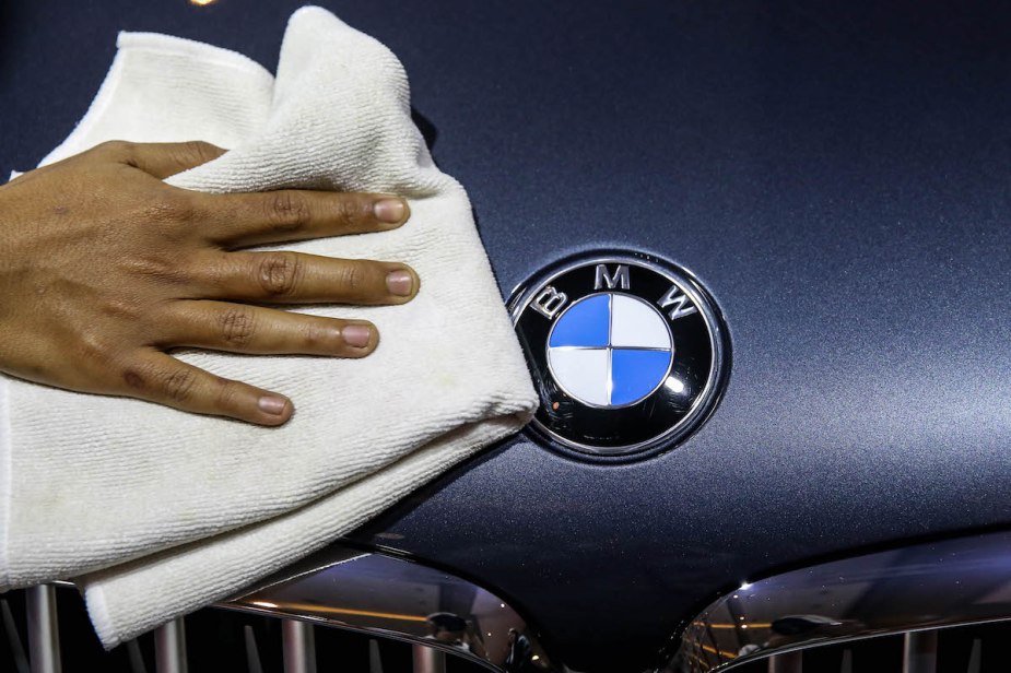 A BMW logo, which is amoung one the most reliable luxury cars. 