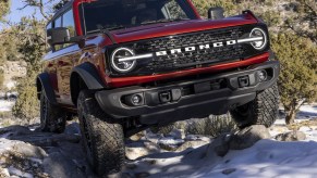 2022 Ford Bronco Wildtrak driving off-road through the snow, it's worth over $50,000