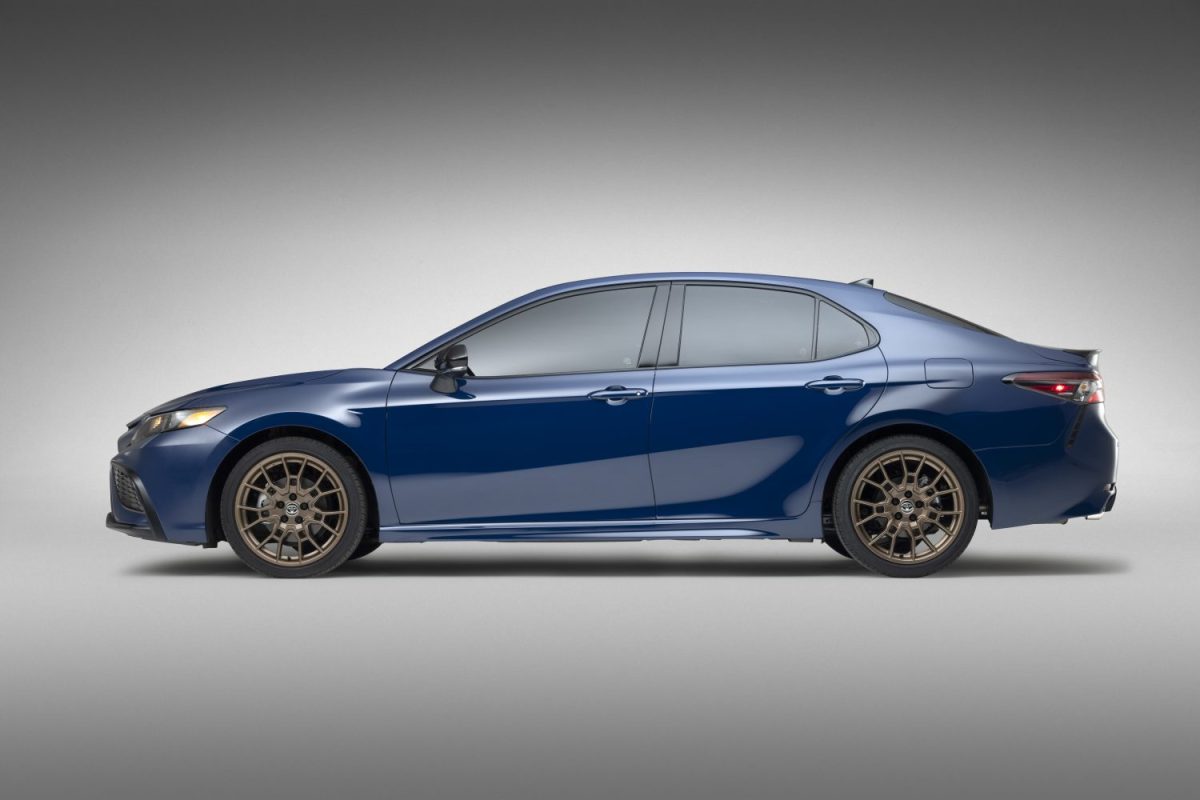 Side profile of the 2023 Toyota Camry in dark blue with bronze wheels