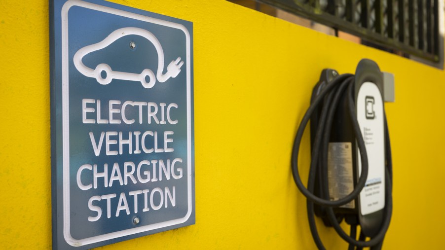 A yellow wall with an electric charging station, which is to an EV that doesn't need a transfer case.