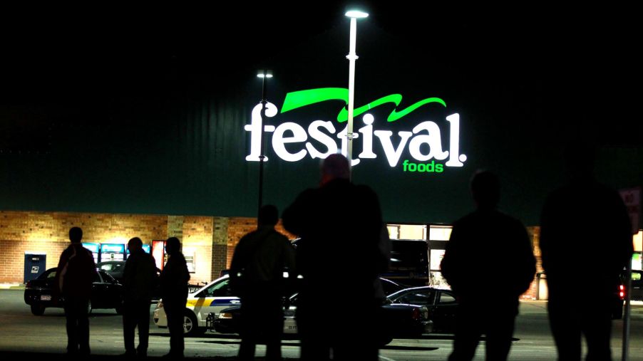A Festival Foods grocery store sign parking lot at night in Brooklyn Park, Minnesota