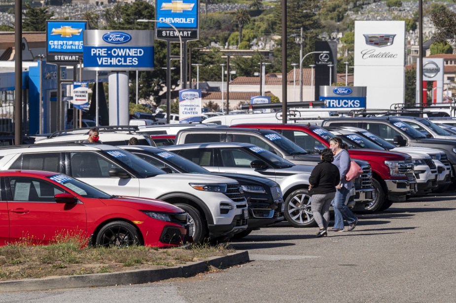 Car shoppers roaming Ford and Cadillac car sales dealerships in Colma, California