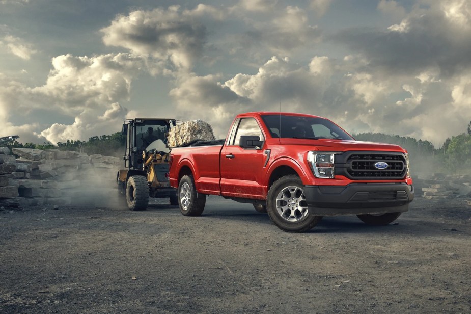 A 2023 Ford F-150 work truck has rubble loaded into its bed.