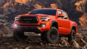 Front angle view of orange 2023 Toyota Tacoma, showing how Toyota has more affordable cars than Honda