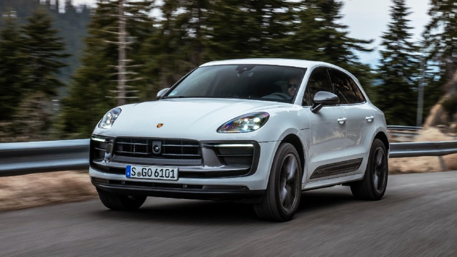 Front angle view of white 2023 Porsche Macan, cheapest new Porsche car and best Car and Driver small luxury SUV