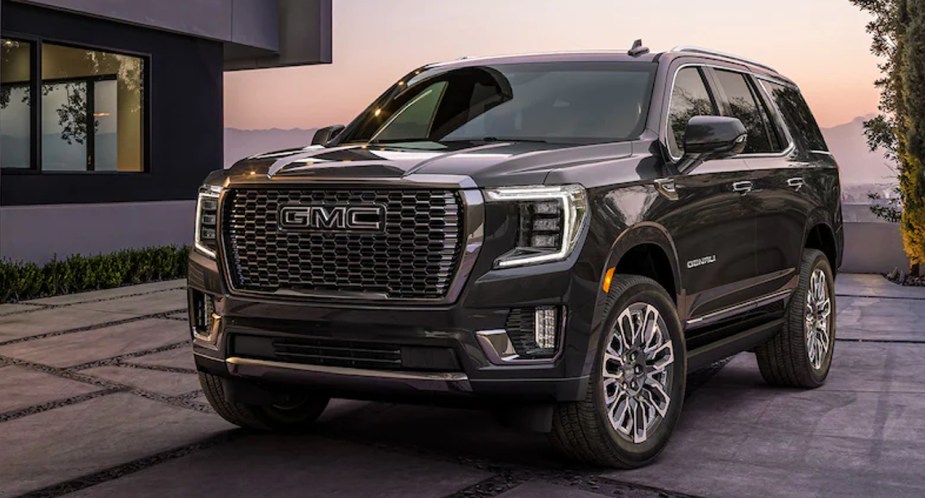 A black 2023 GMC Yukon full-size SUV is parked. 