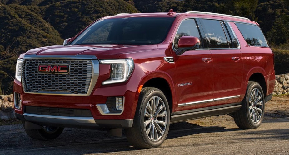 A red 2023 GMC Yukon full-size SUV is parked. 