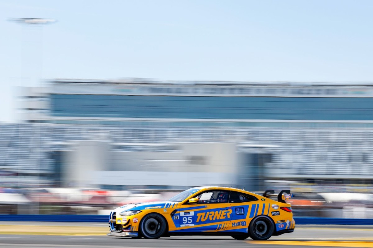 A BMW M4 race car on track at Daytona.