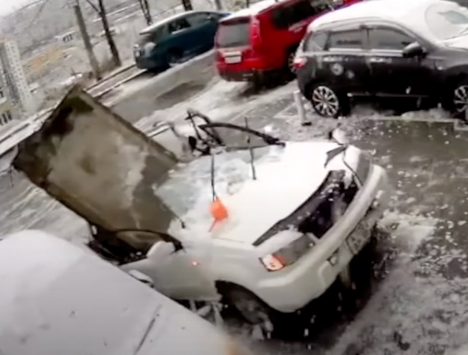 In viral YouTube video from Russia, a big concrete slab sits upright in destroyed car after falling from building  