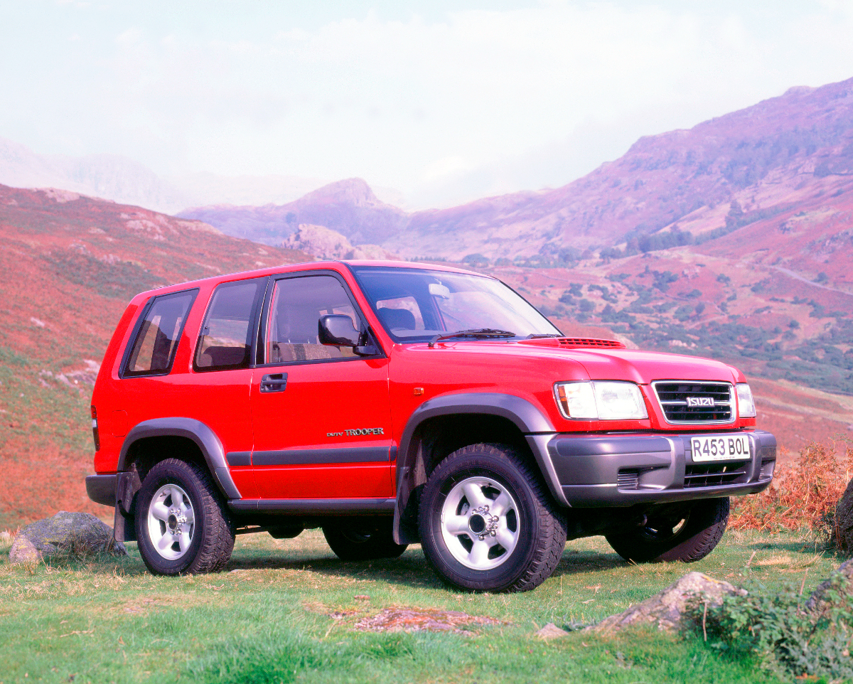 A red Isuzu Trooper sits in a remote location as an off-road SUV.