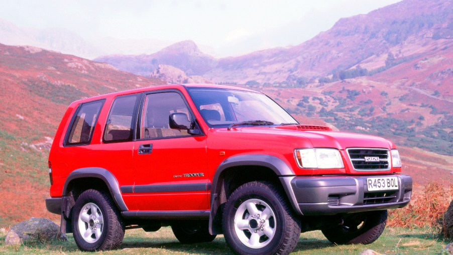 A red Isuzu Trooper sits in a remote location as an off-road SUV.