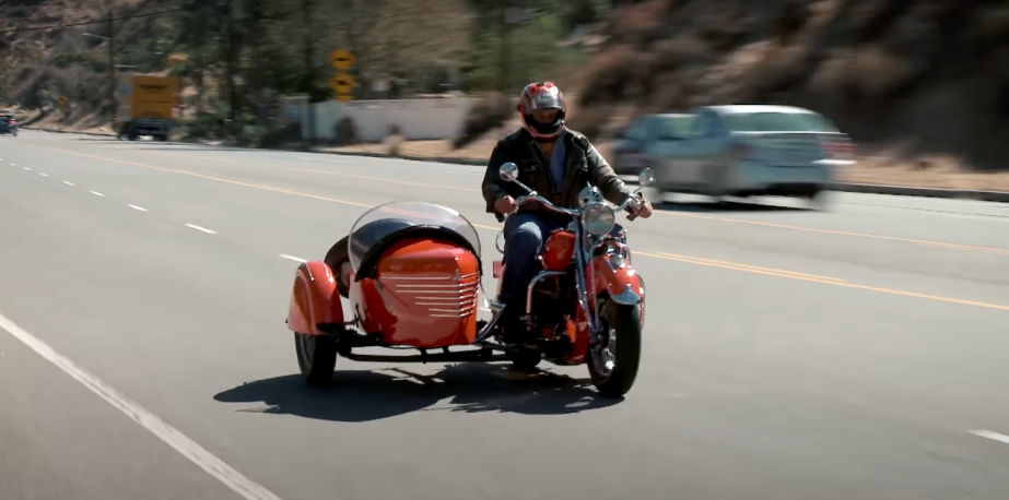 Jay Leno drives a 1940 Indian motorcycle with a sidecar in los angeles, before he crashed it and broke several bones.