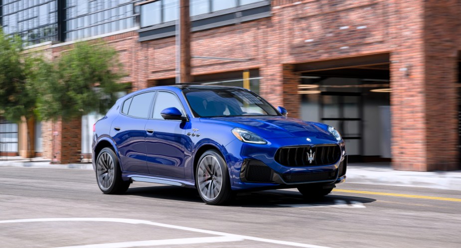 A blue 2023 Maserati Grecale small luxury SUV is driving on the road. 