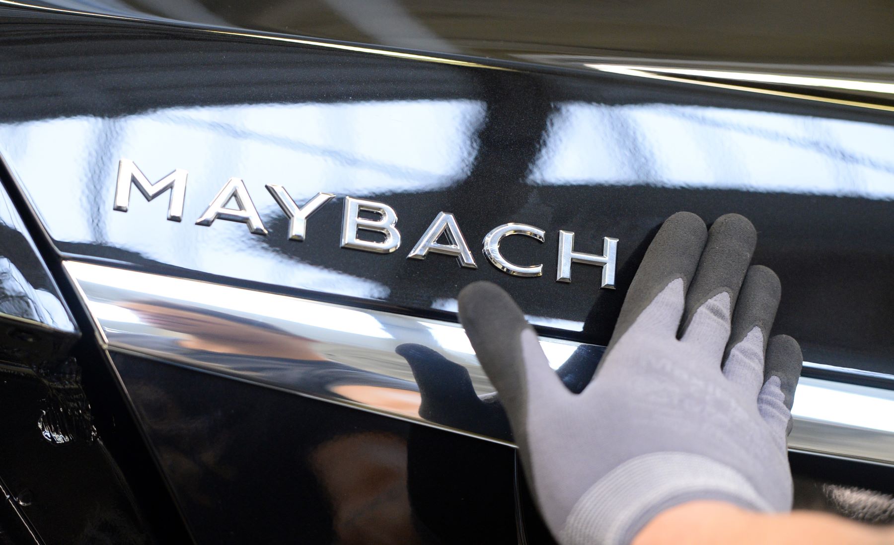 Maybach badging attached to a Mercedes-Benz model during vehicle assembly in Sinfelfingen, Germany