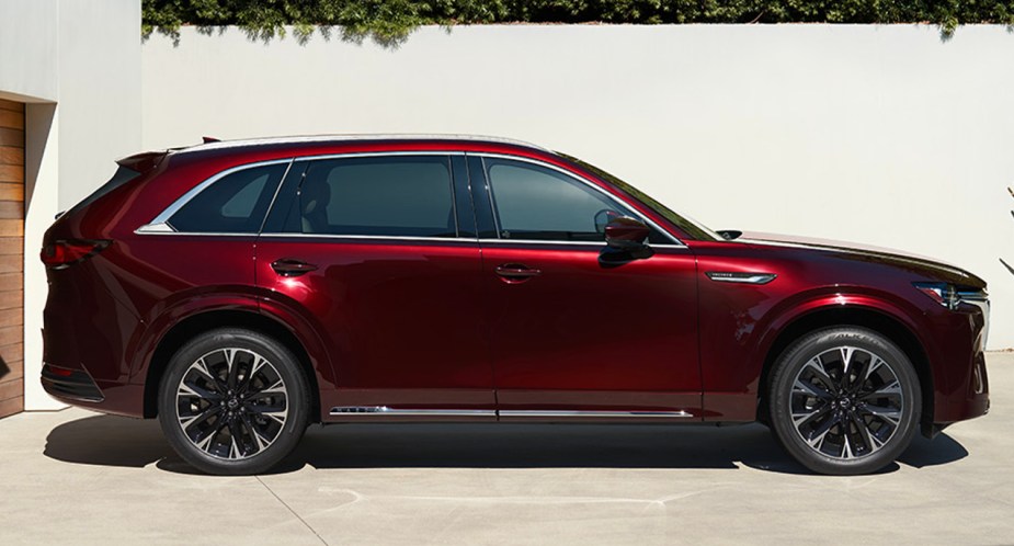 A red 2023 Mazda CX-90 midsize SUV is parked. 