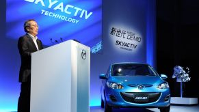 A Mazda conference in Tokyo, Japan, showcasing the Demio car equipped with the SKYACTIV-G 1.3 engine
