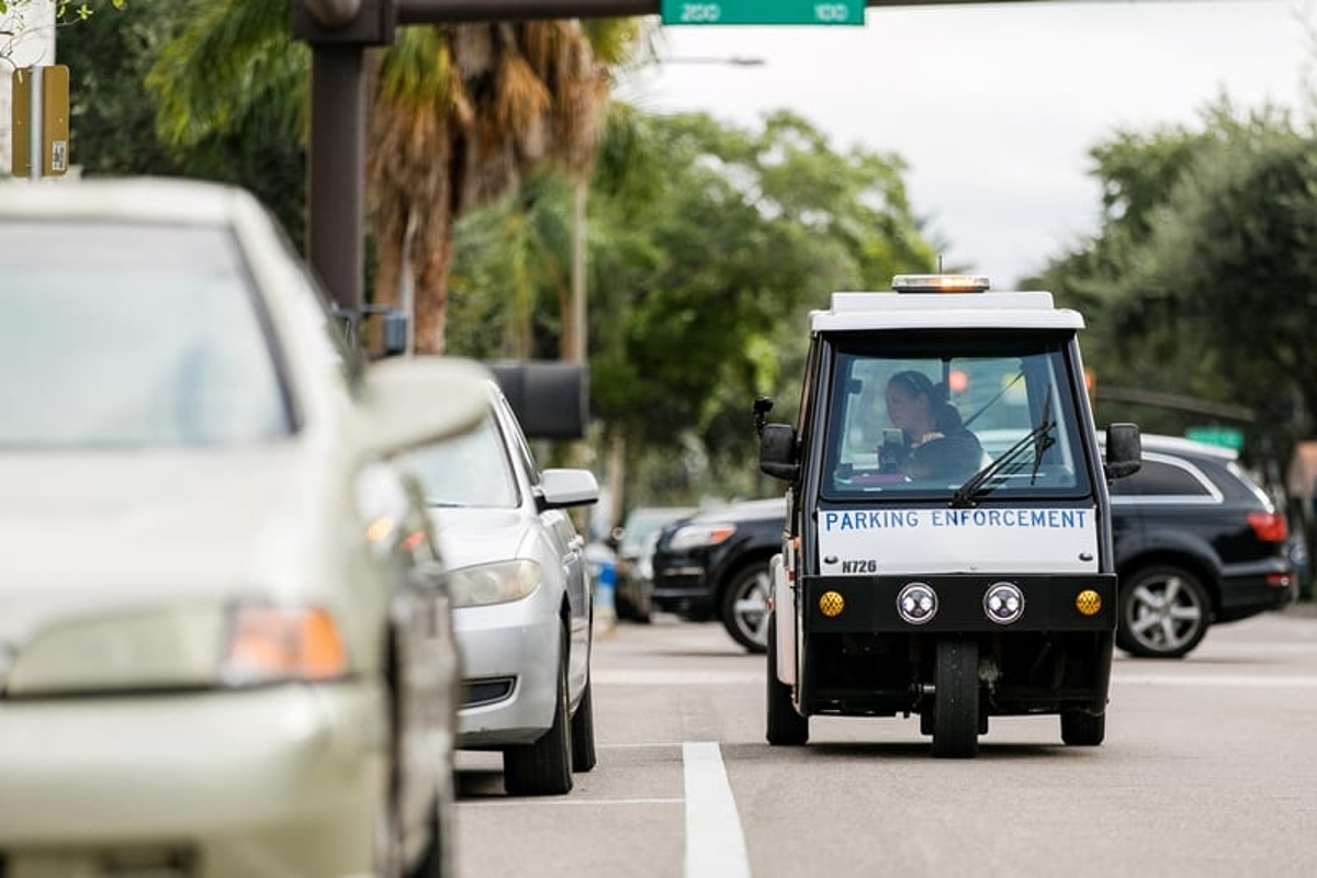 A meter maid car patrols the streets, it is Doug DeMuro's worst car of 2022.