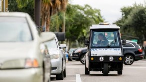 A meter maid car patrols the streets, it is Doug DeMuro's worst car of 2022.