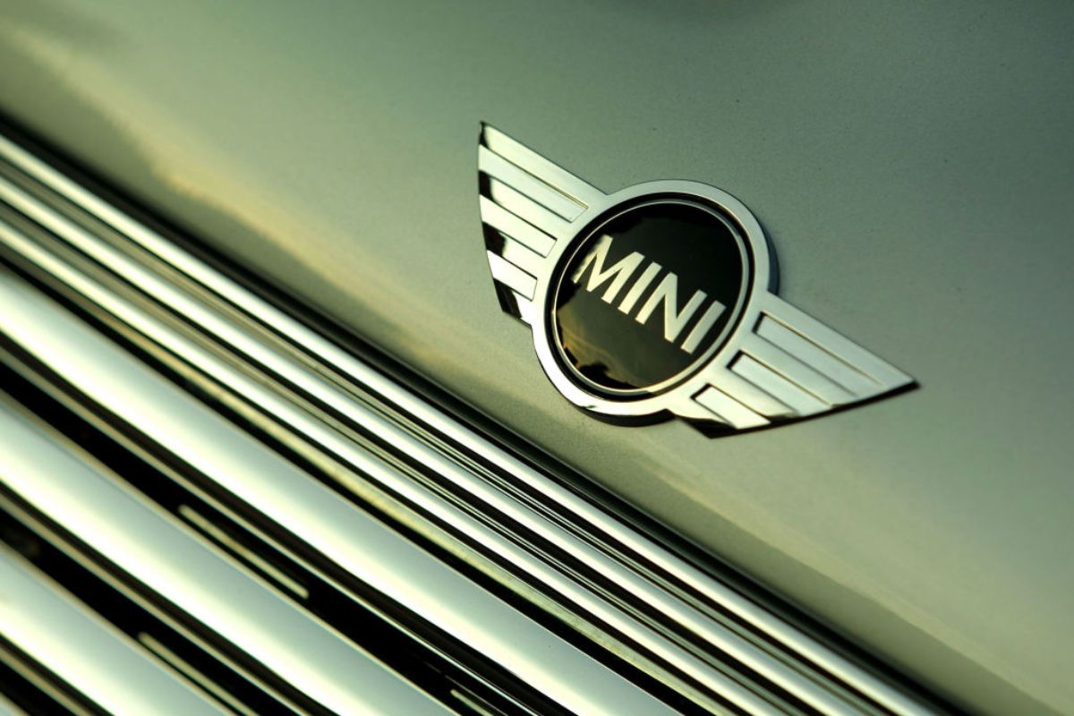 A logo on the front of a Mini Cooper.