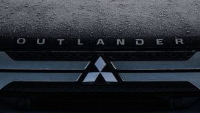 The hood of a Mitsubishi Outlander SUV model covered in rain in Dublin, Ireland
