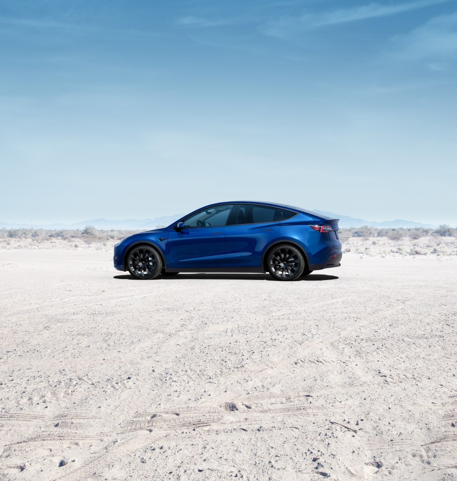 A 2022 Tesla Model Y used its bright blue paint to contrast with the sand in the bright desert.