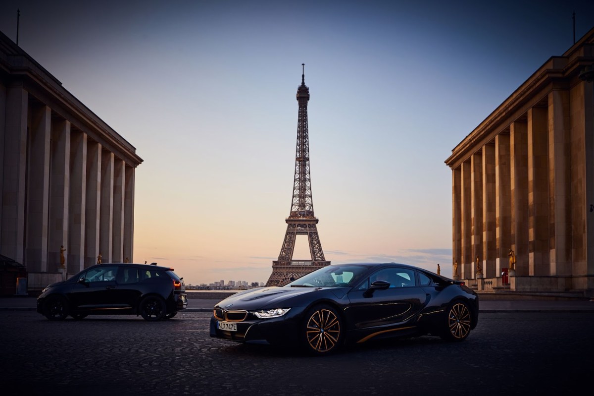 A black BMW i8 coupe in front of the Eiffel Tower