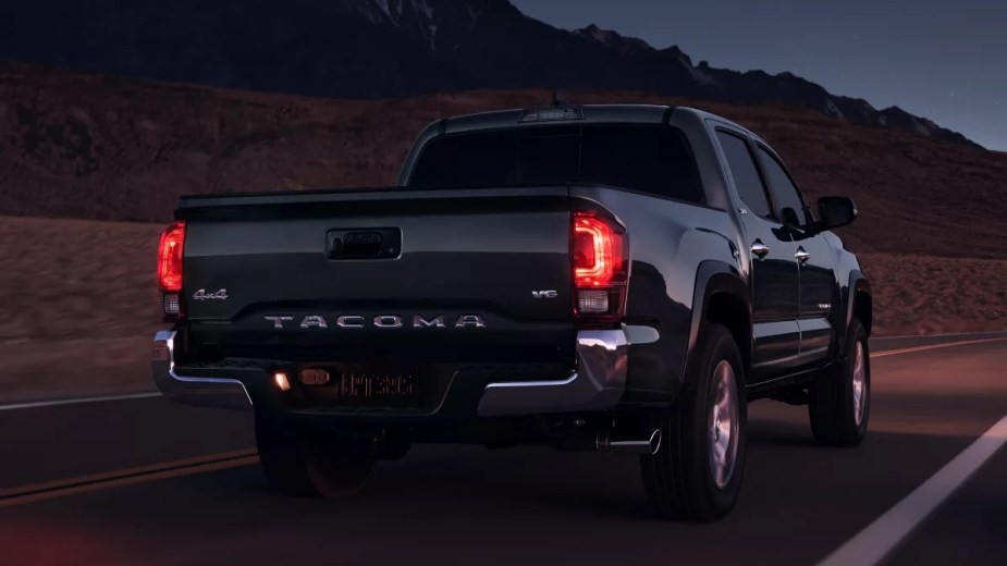 Rear view of the black 2023 Toyota Tacoma midsize pickup truck